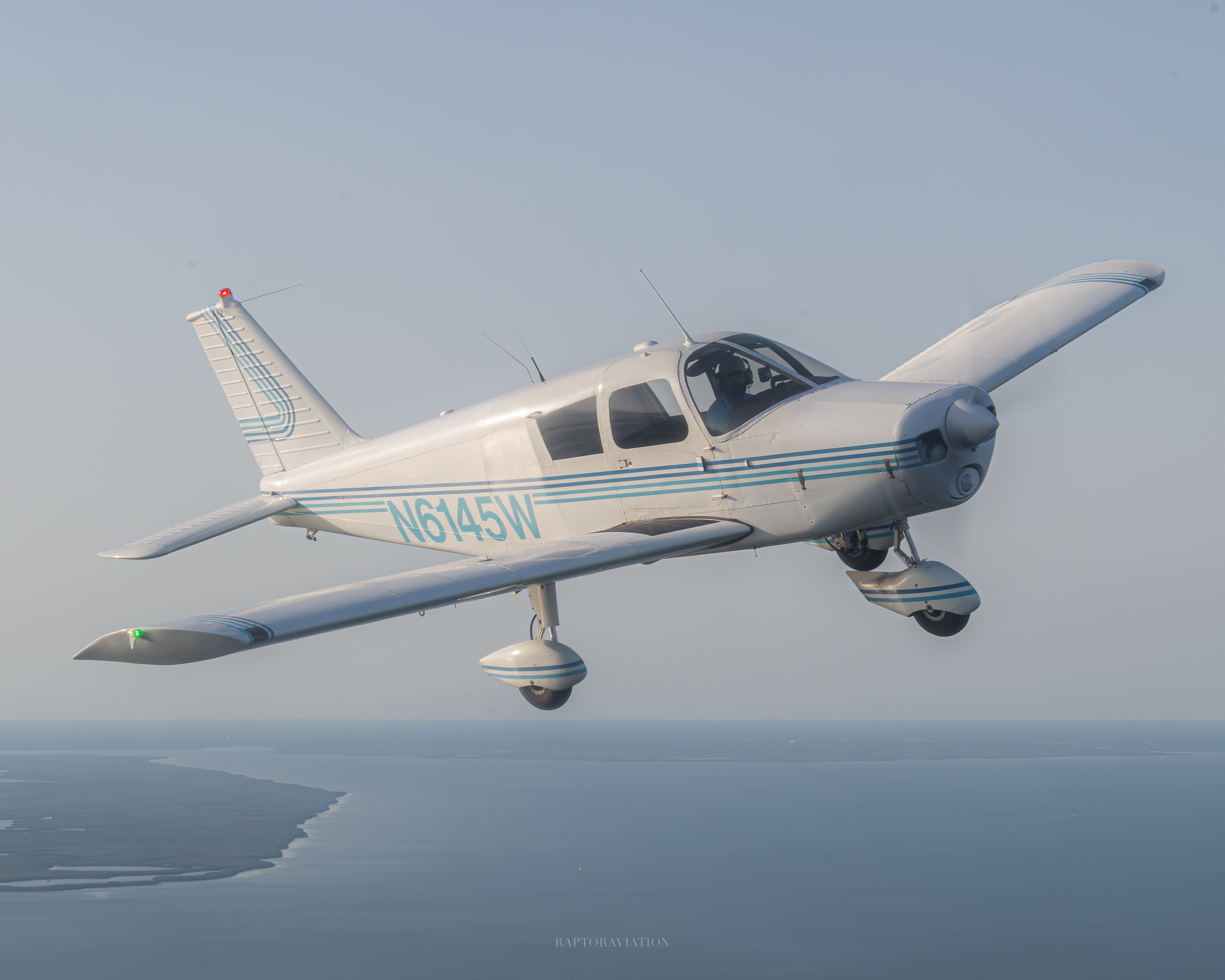 Piper Cherokee N6145W in flight over Florida coastline