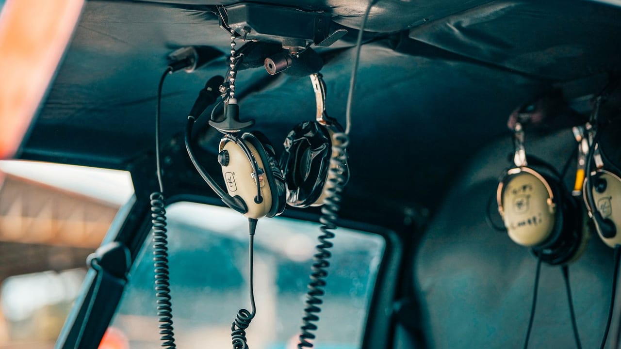 Aviation headsets hanging in the cabin of a light aircraft